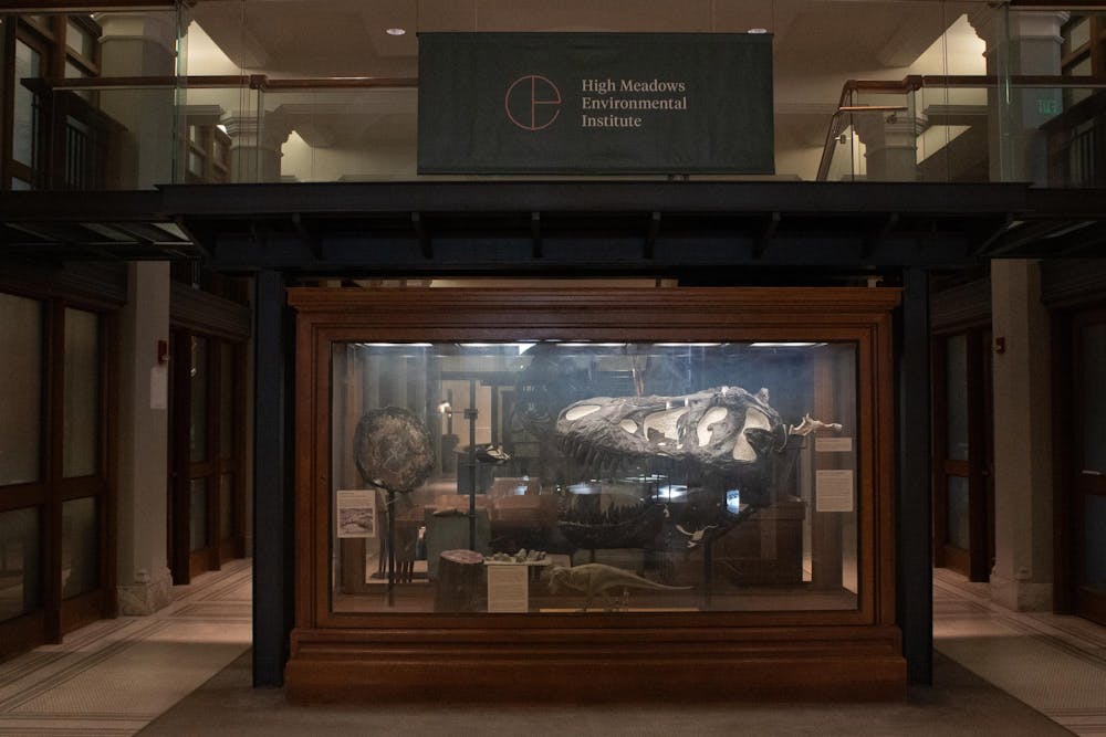Photo of a High Meadows Environmental Institute banner above a display case of fossils.