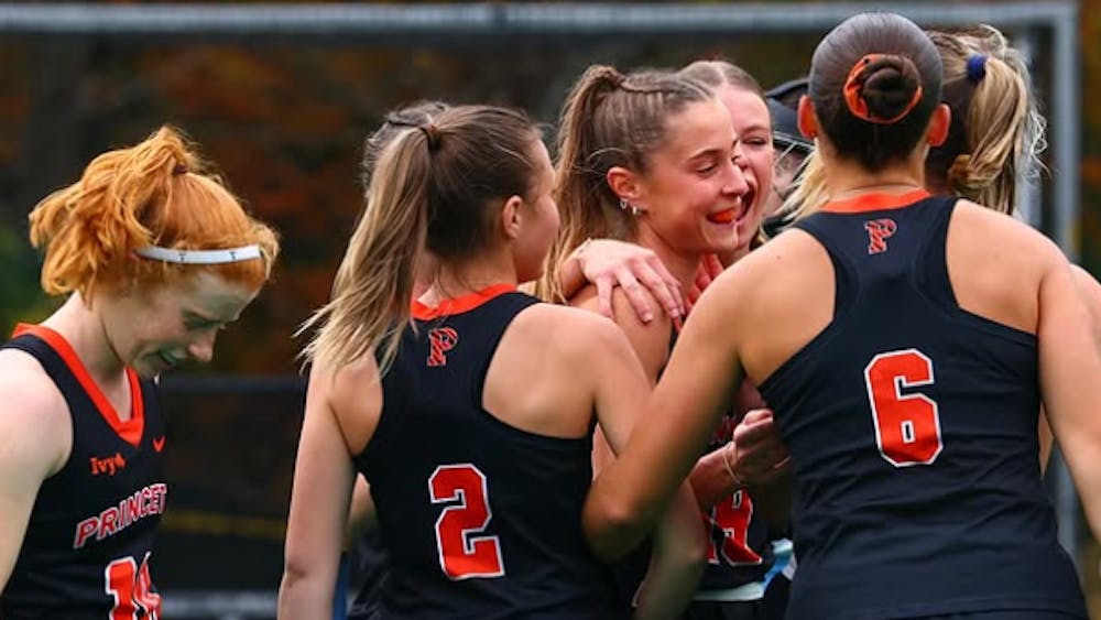 Princeton field hockey in a huddle.