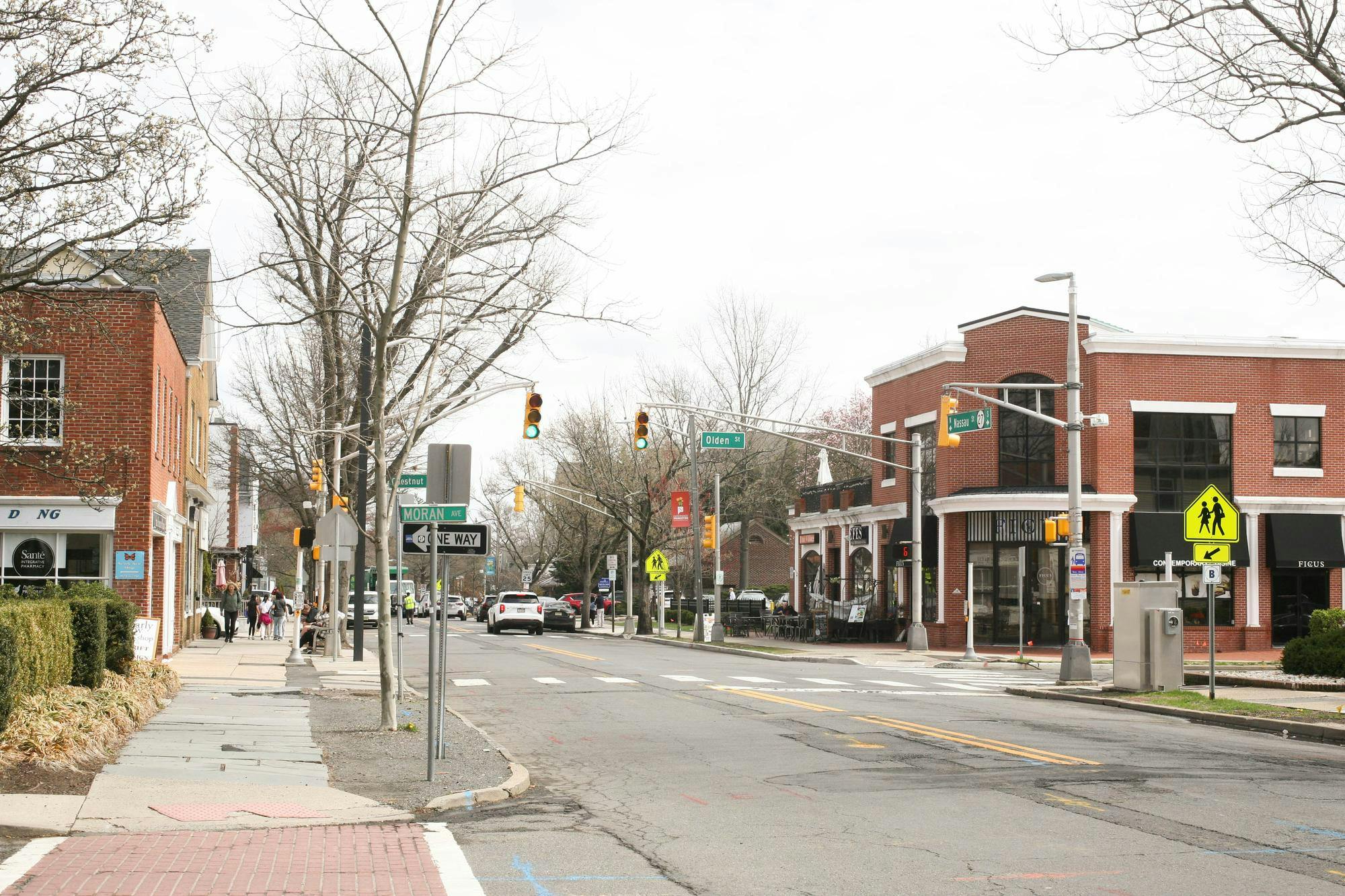 A typical street intersection with a crosswalk and traffic lights.
