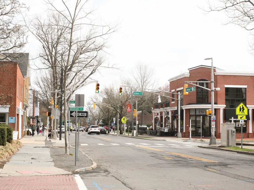A typical street intersection with a crosswalk and traffic lights.