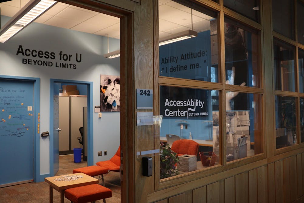 Featured is a glass room with wood borders with the words "AccessAbility Center" on the front. The room has a bright blue door and paler blue walls.