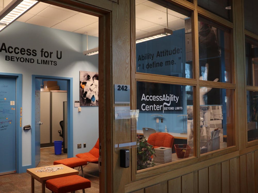 Featured is a glass room with wood borders with the words "AccessAbility Center" on the front. The room has a bright blue door and paler blue walls.