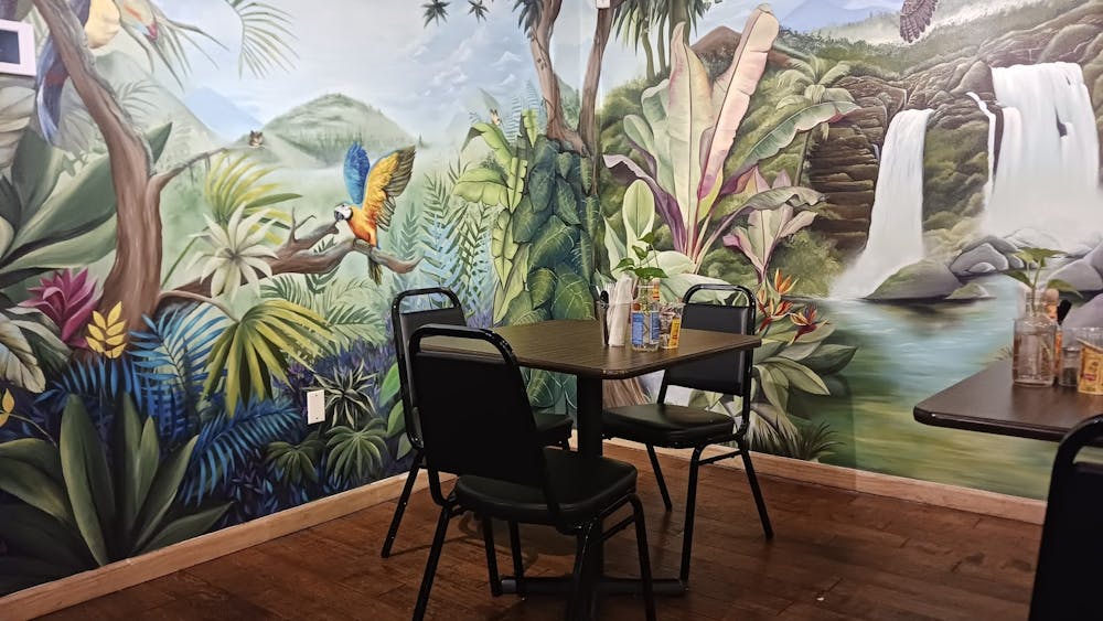 A table at Planted Plate in front of a rainforest mural.
Albert Lee / The Daily Princetonian