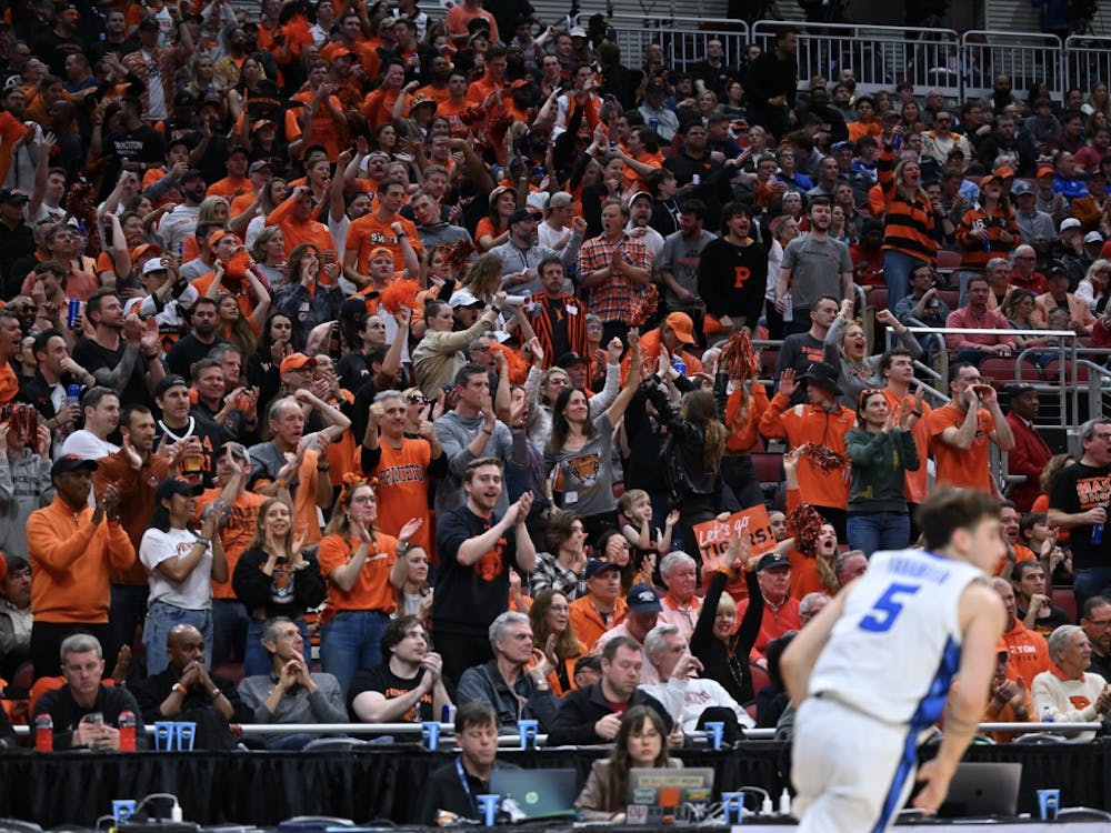 Tiger fans wearing orange and black at the 2023 NCAA Tournament supporting the men’s basketball team in the stands.