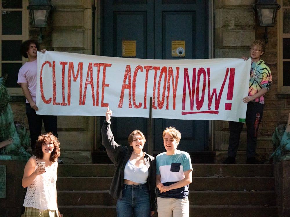 <h5>Students lead a chant during the Divest Princeton sit-in in front of Nassau Hall. The goal of the sit-in was to call for urgent and complete divestment from the fossil fuel industry.</h5>
<h6>Candace Do / The Daily Princetonian</h6>