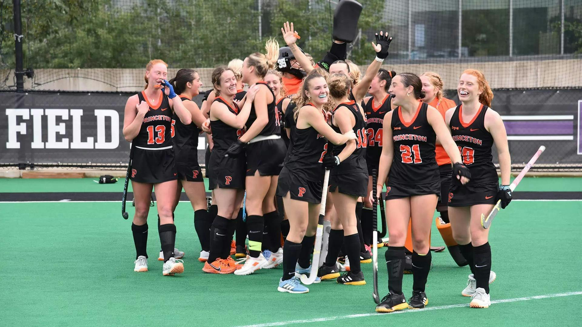 Players huddling on fielding in celebration.