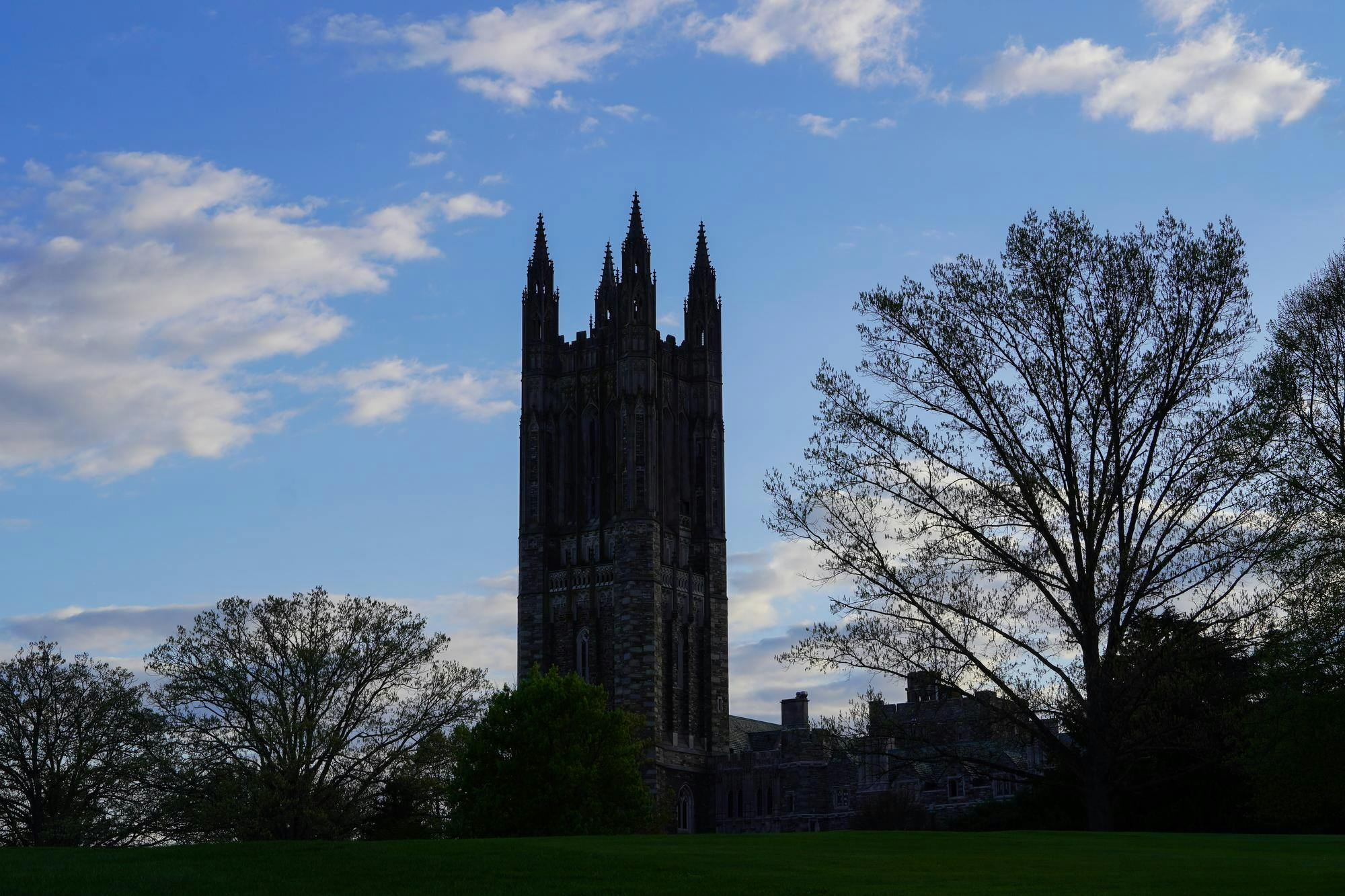 The graduate tower during the day with a shadow cast over it.