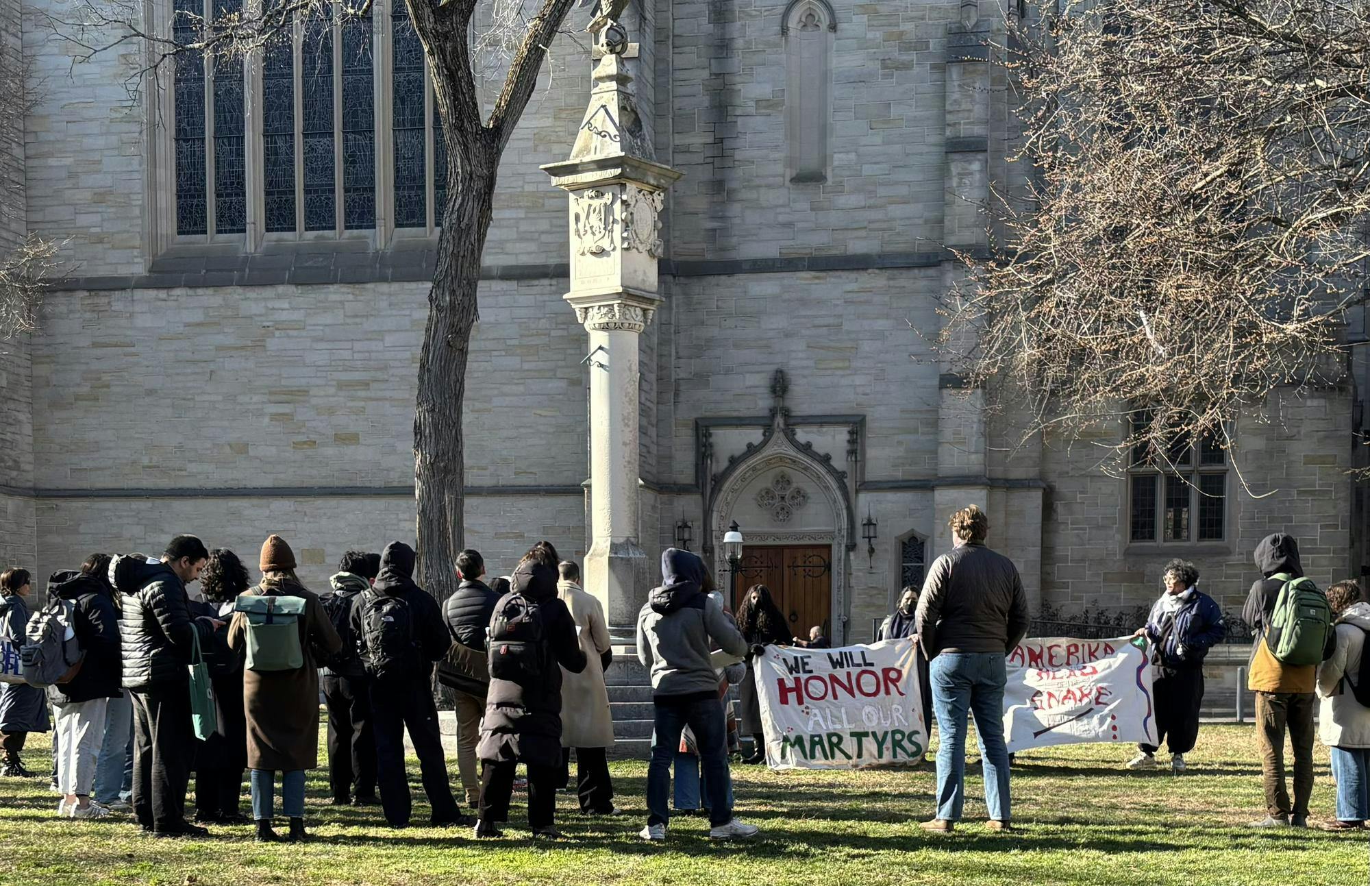 People gathered with a sign "we will honor our martyrs."