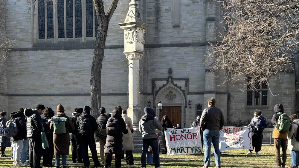 People gathered with a sign "we will honor our martyrs."