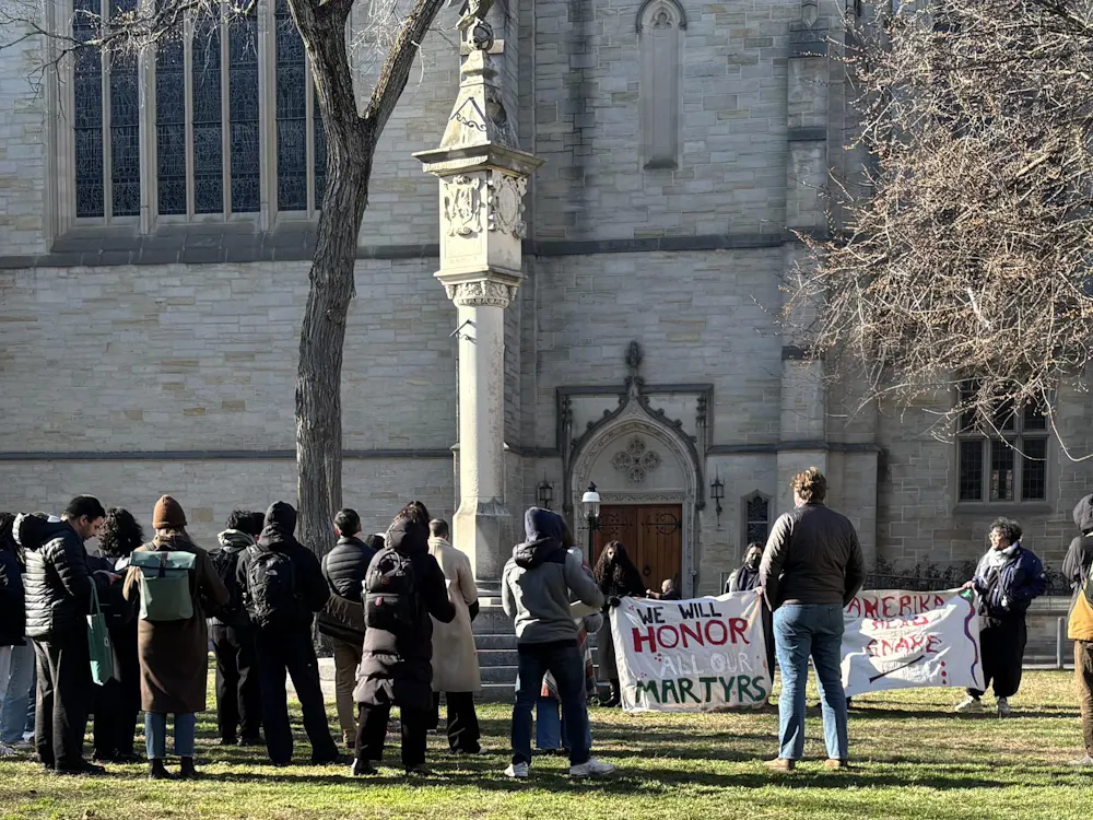 People gathered with a sign "we will honor our martyrs."
