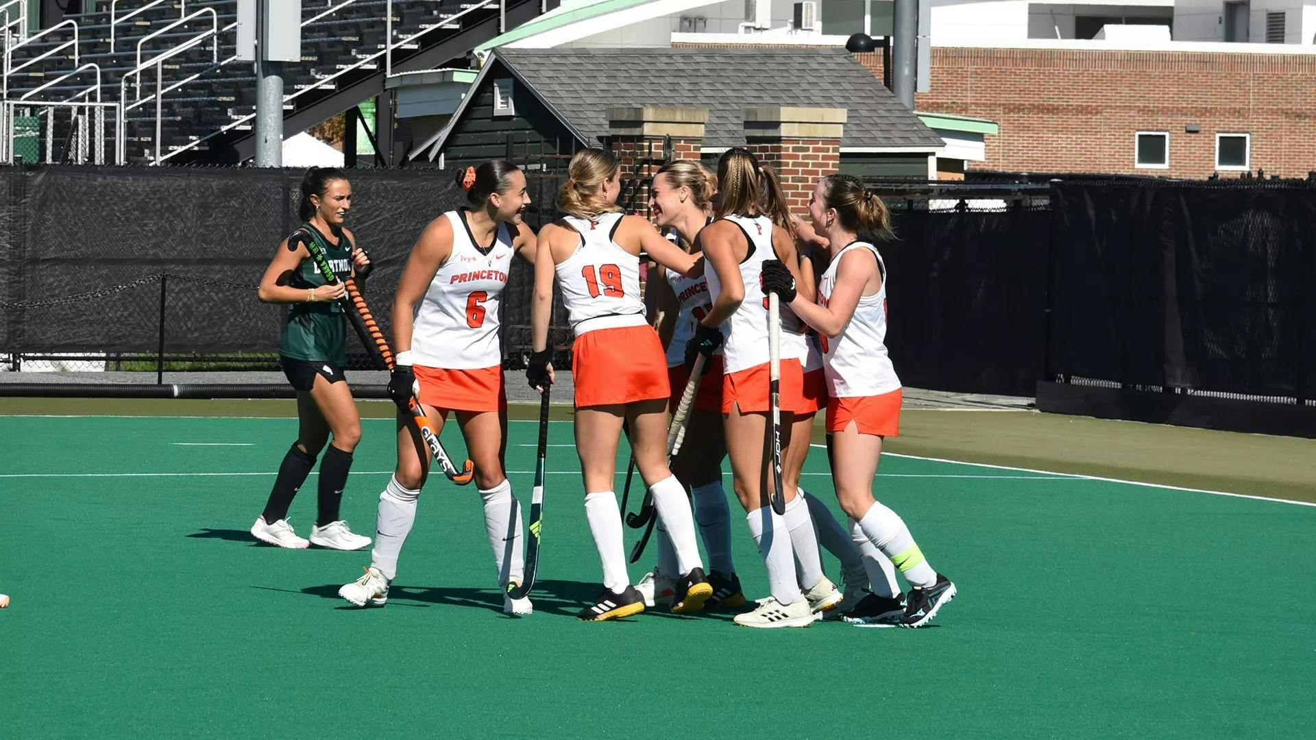 Players huddling on field.