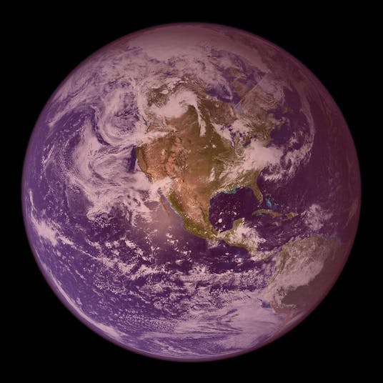 A photo of the Earth taken from space with a purple tint over the whole planet.