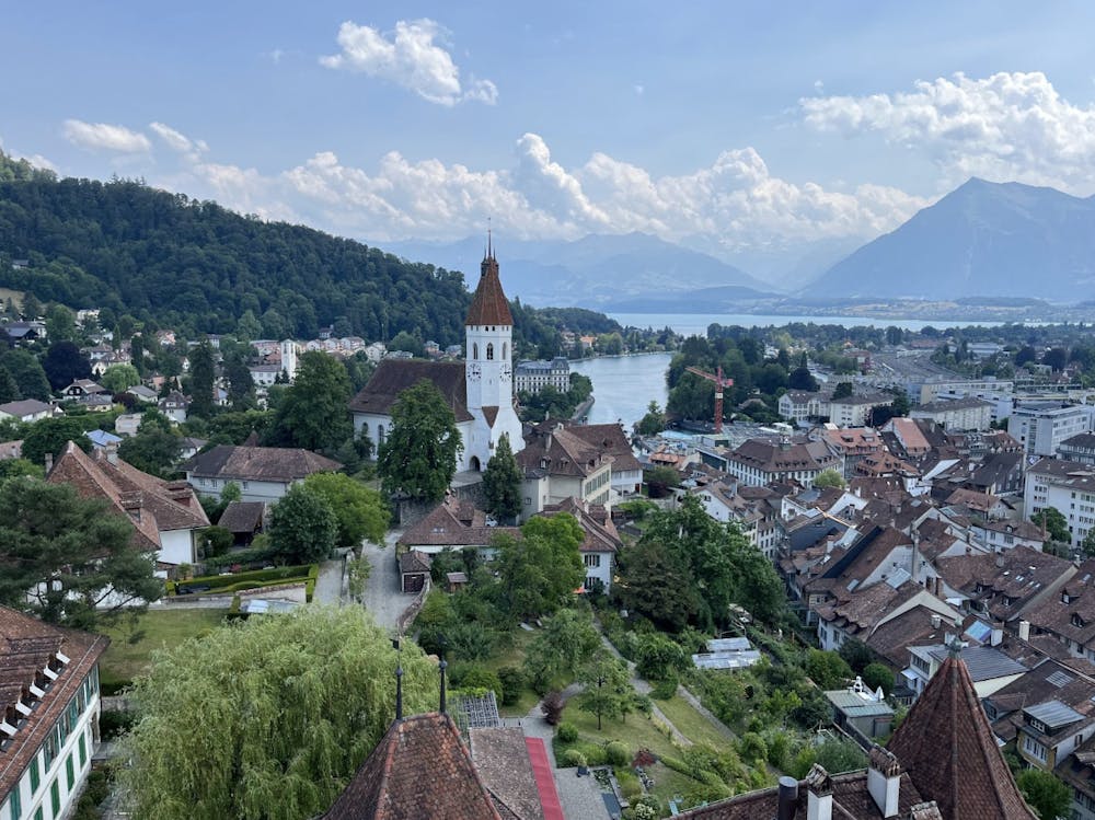 Photo of the Swiss Alps surrounding a small European town on a river.