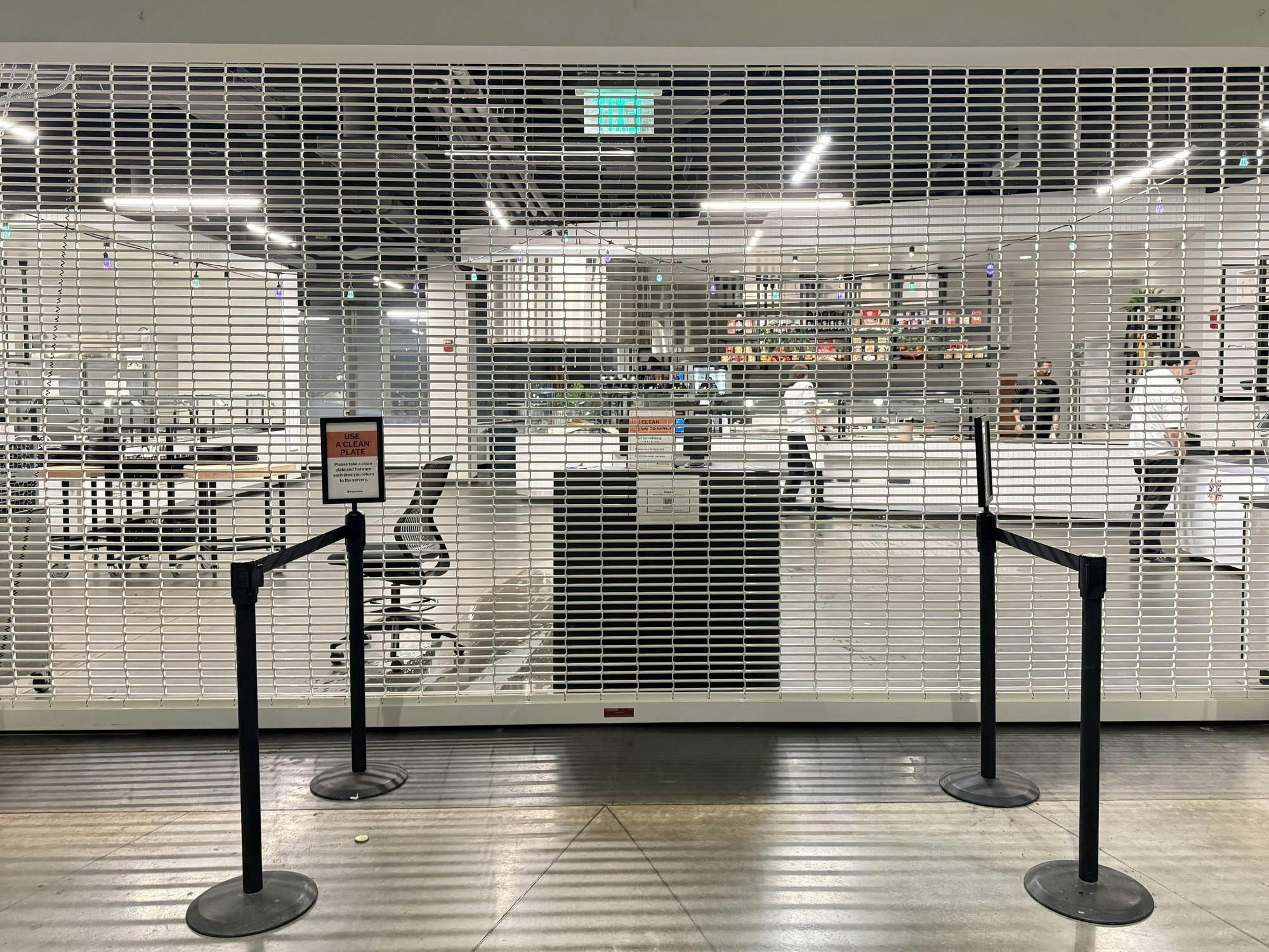 A gate has been pulled down in front of a dining hall entrance.