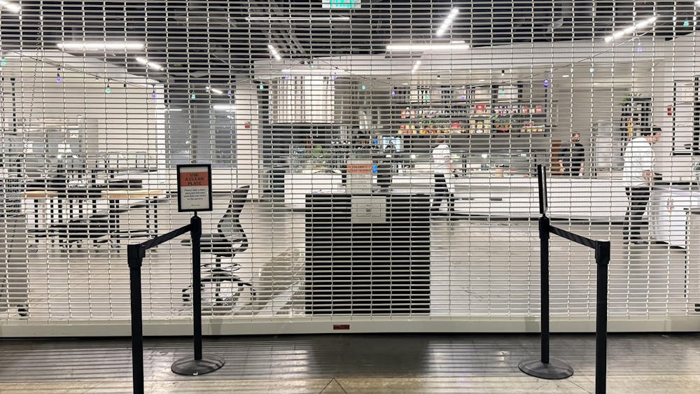 A gate has been pulled down in front of a dining hall entrance.