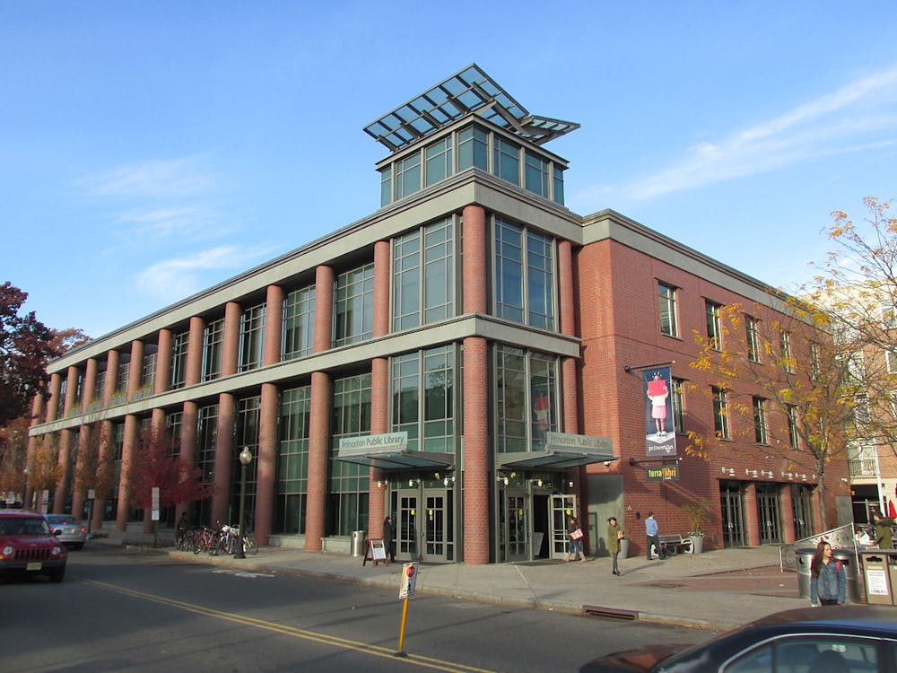 Image of a building with brick columns on a slightly cloudy day.