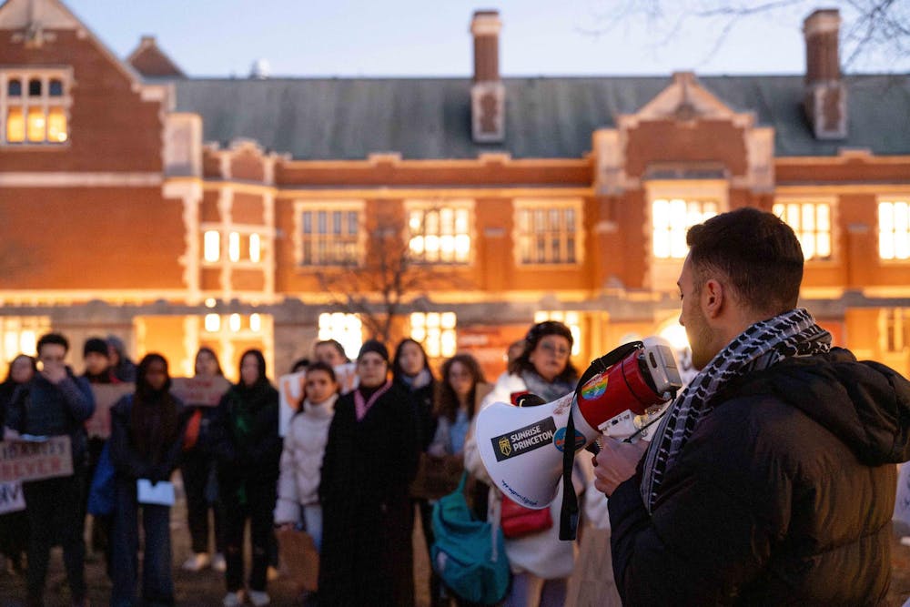 Students and community members stand in front of Frist.