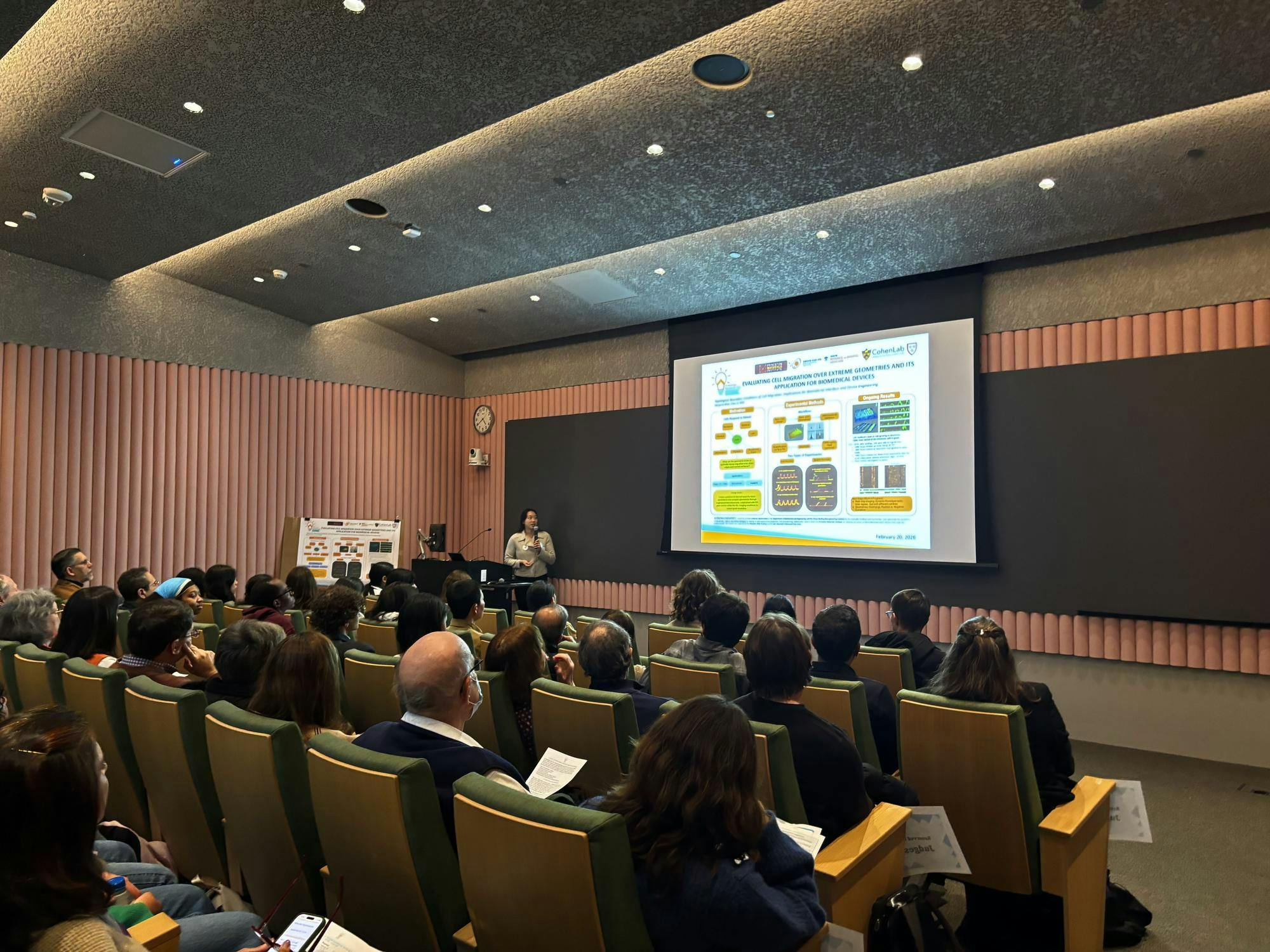 A group of people sitting in a lecture hall.