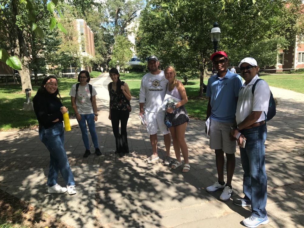 Sakura Price ’23 (left) and her tour group, including high school senior Erika Petterson and her father, Chad Petterson (center).&nbsp;
Edward Tian / The Daily Princetonian