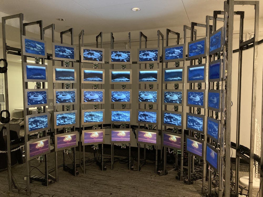 A semi-circular arrangement of five rows with nine screens each.