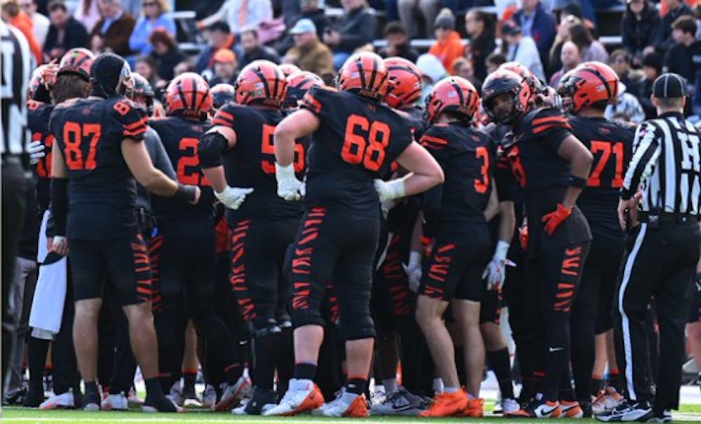 Princeton football players in a huddle.