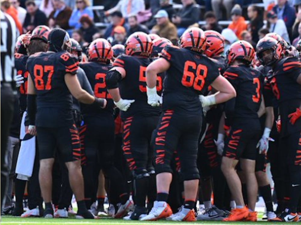 Princeton football players in a huddle.