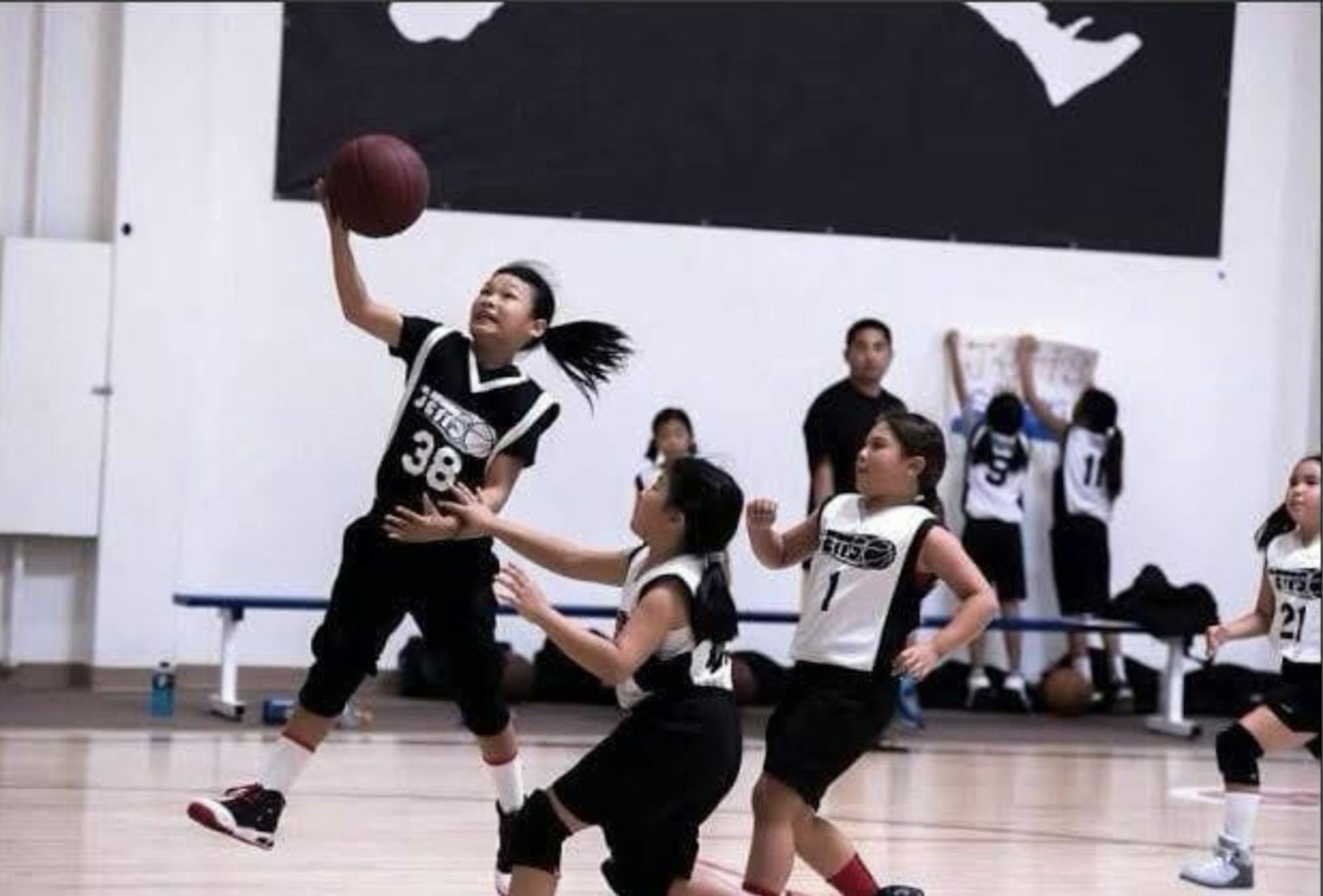 Girl playing basketball.