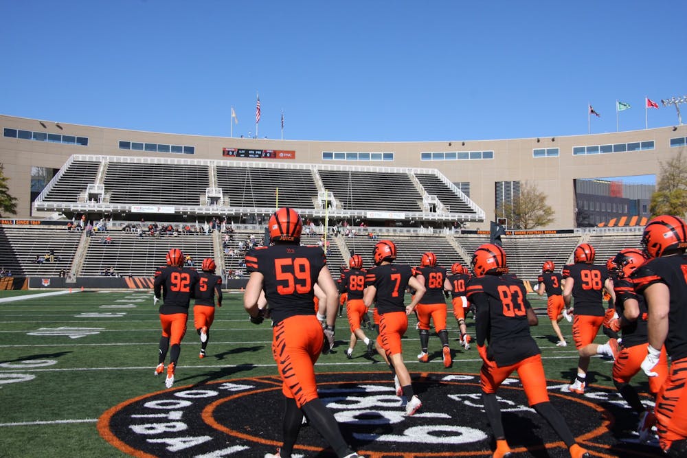 A group of men running off a football field. 