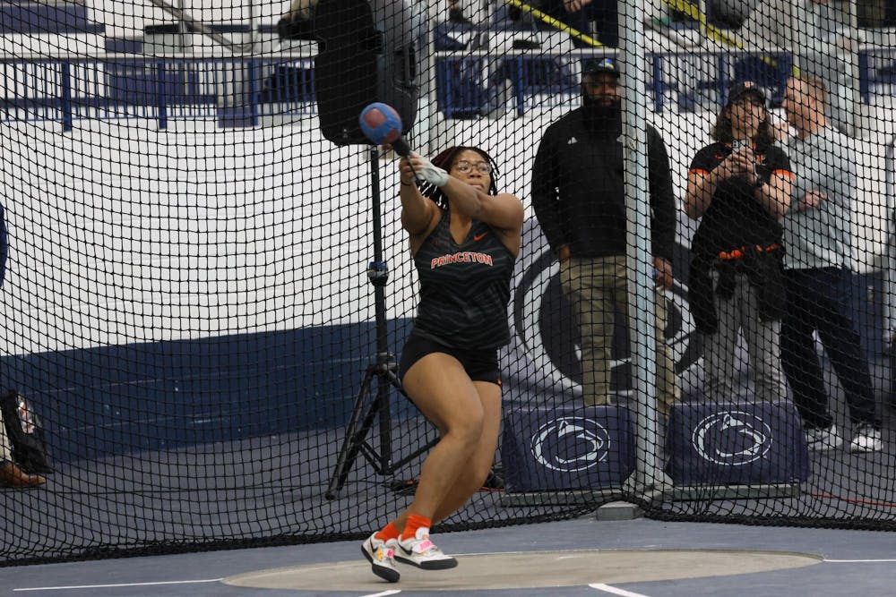 Woman throwing in track event. 