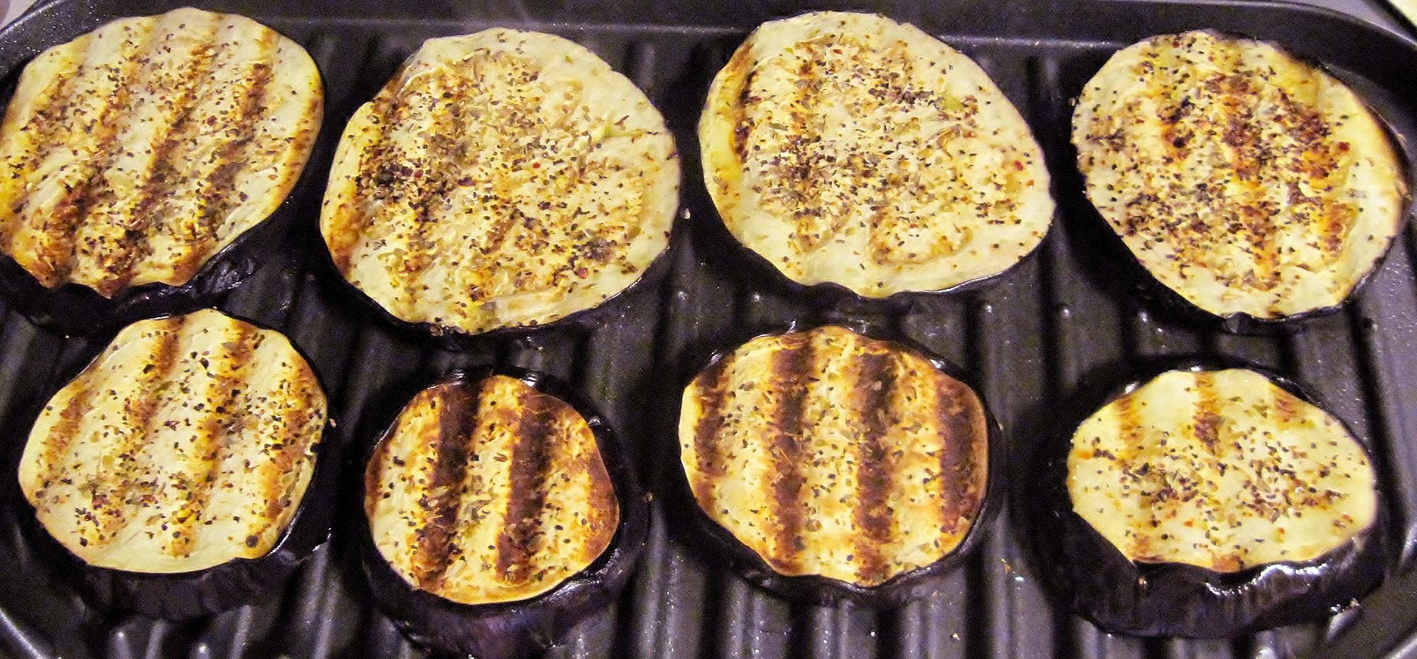 Grilling eggplant on grill.