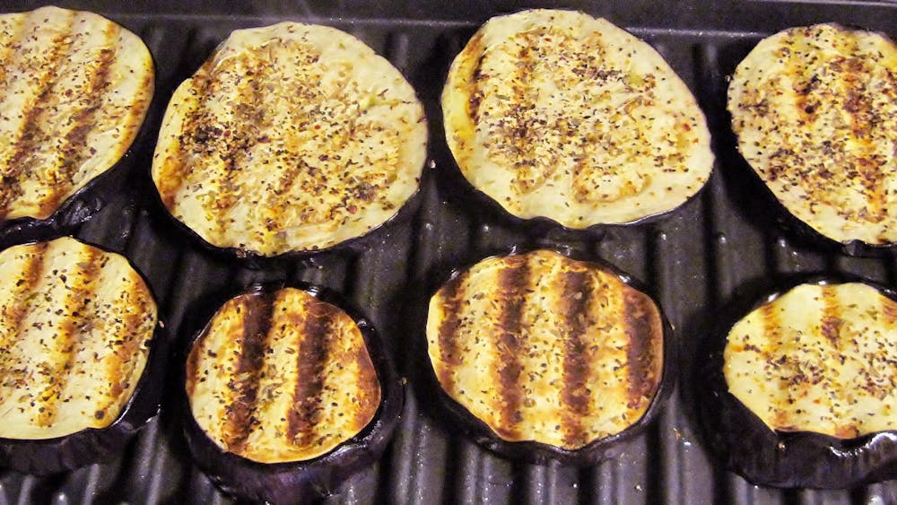 Grilling eggplant on grill.