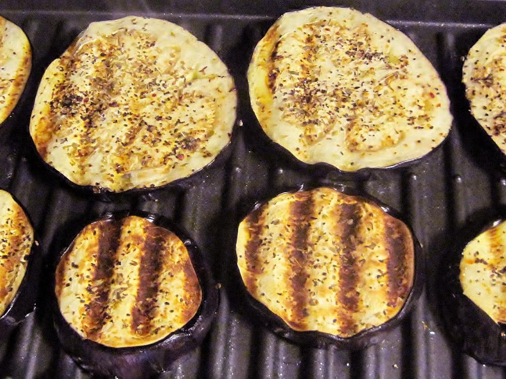 Grilling eggplant on grill.
