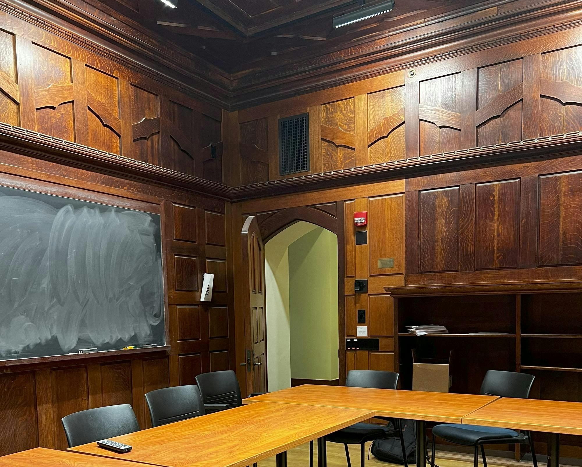 Dark wood room and black board with chalk.