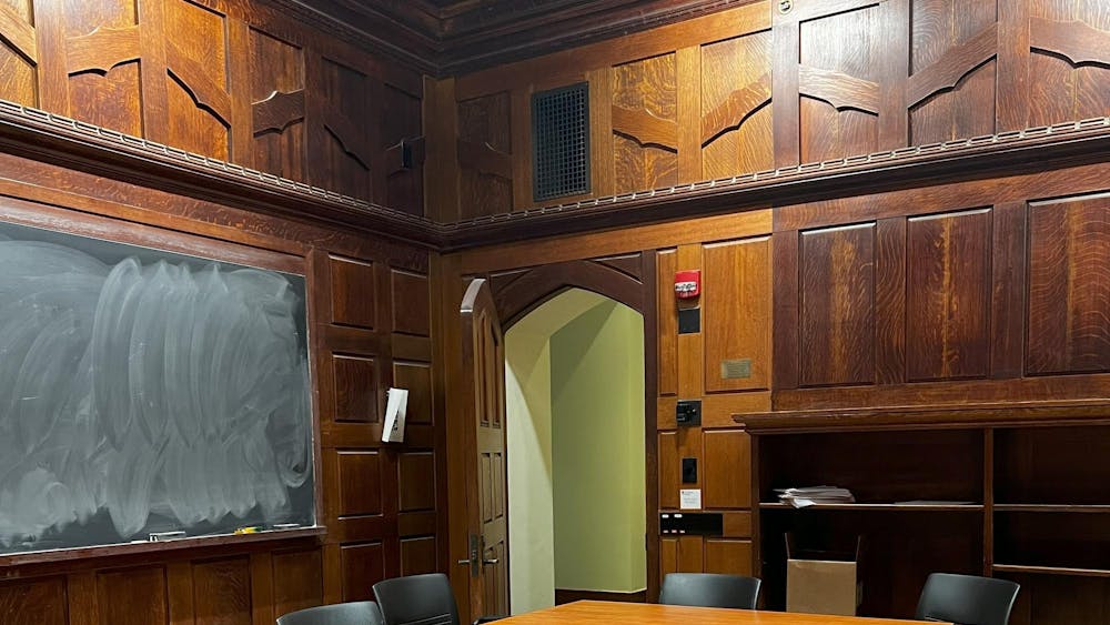 Dark wood room and black board with chalk.
