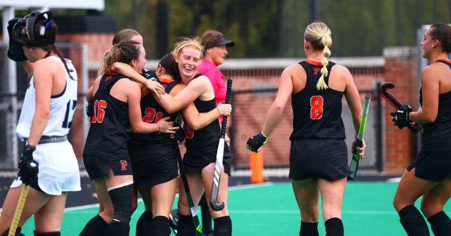 Princeton field hockey in huddle.