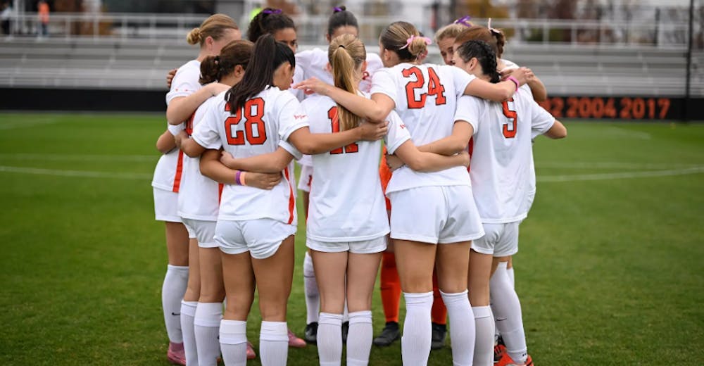 Princeton women's soccer team in a huddle.