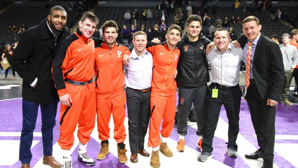 Kolodzik, Brucki, and Glory pose with their coaches after placing at the Midlands Championship 