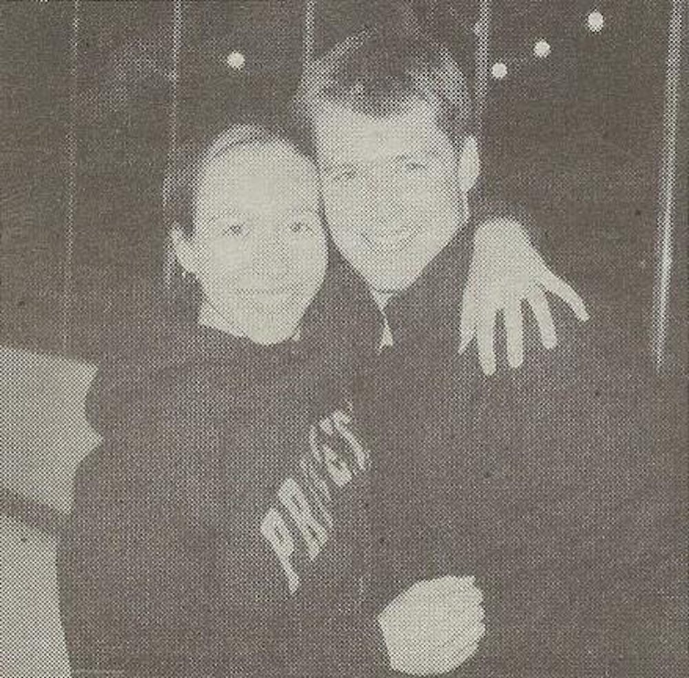 A black and white photograph of Jessica Falencki hugging her soon-to-be husband, Joe Falencki
