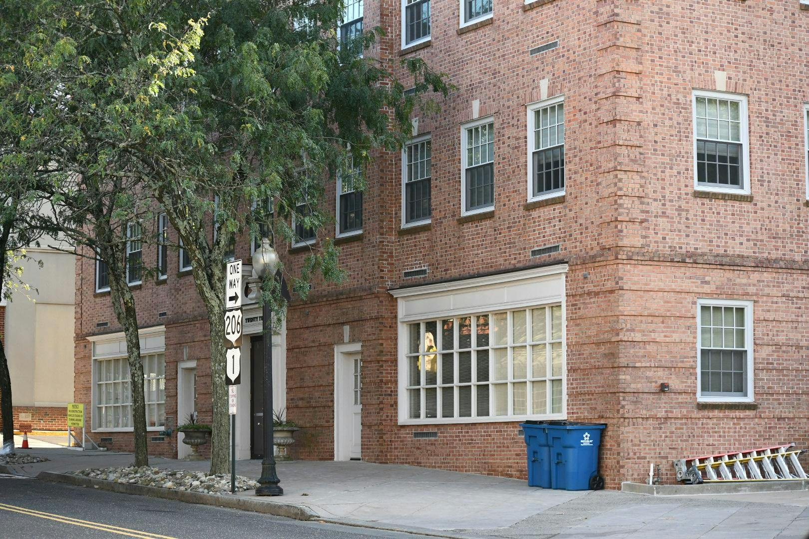 A rectangular brick building with the address "twenty two" above the door