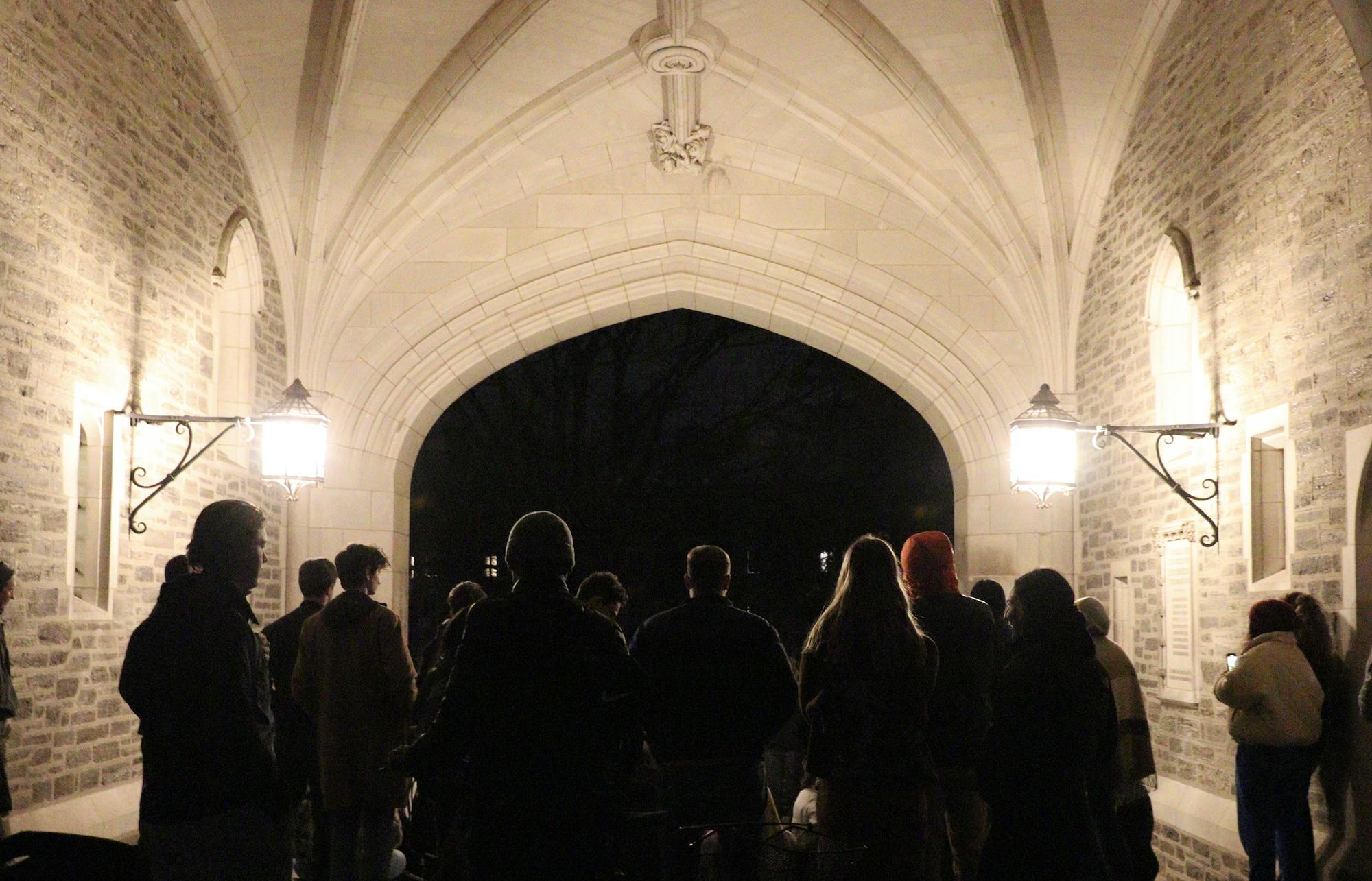 A photo of many people in Blair arch facing away from the camera looking towards the stairs of the arch.  