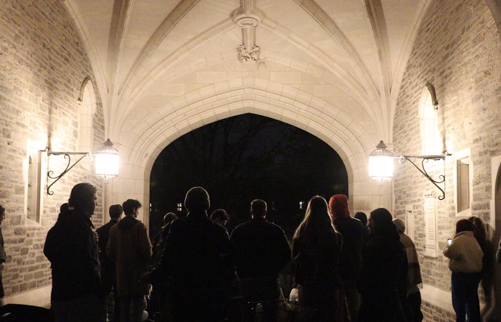 A photo of many people in Blair arch facing away from the camera looking towards the stairs of the arch.  