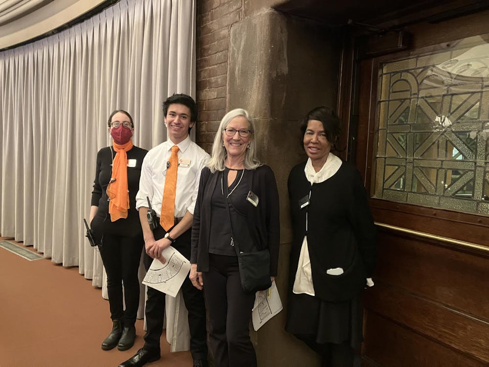 Four theater employees stand together smiling.