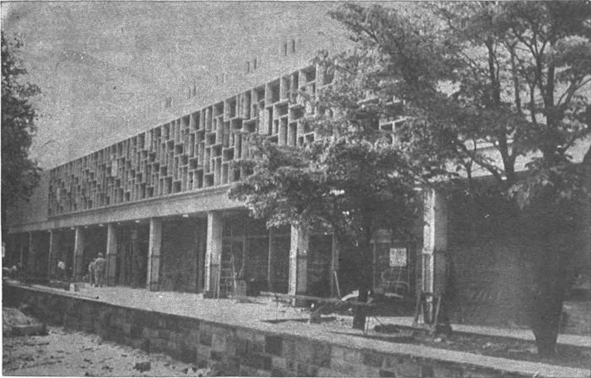 Black and white photograph of Wilcox Hall surrounded by construction material, shortly before its completion.