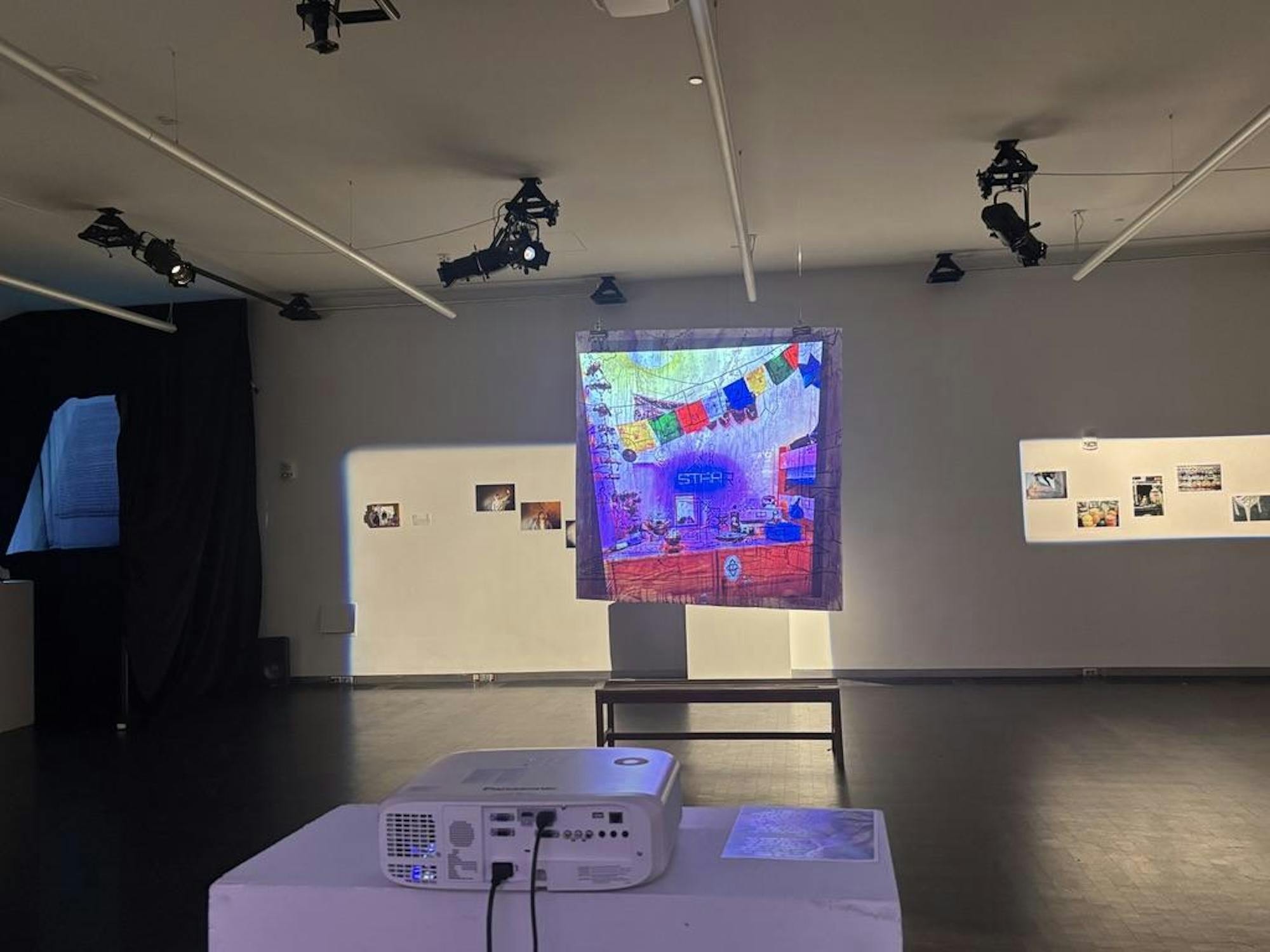 A colorful artwork is projected on a screen in the middle of a room