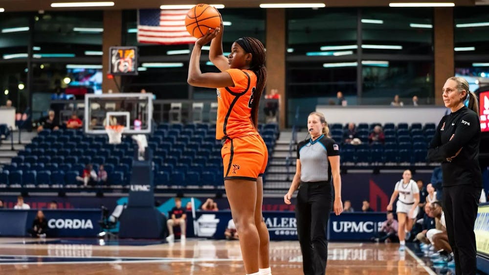 Women’s basketball player shoots from the foul line. 