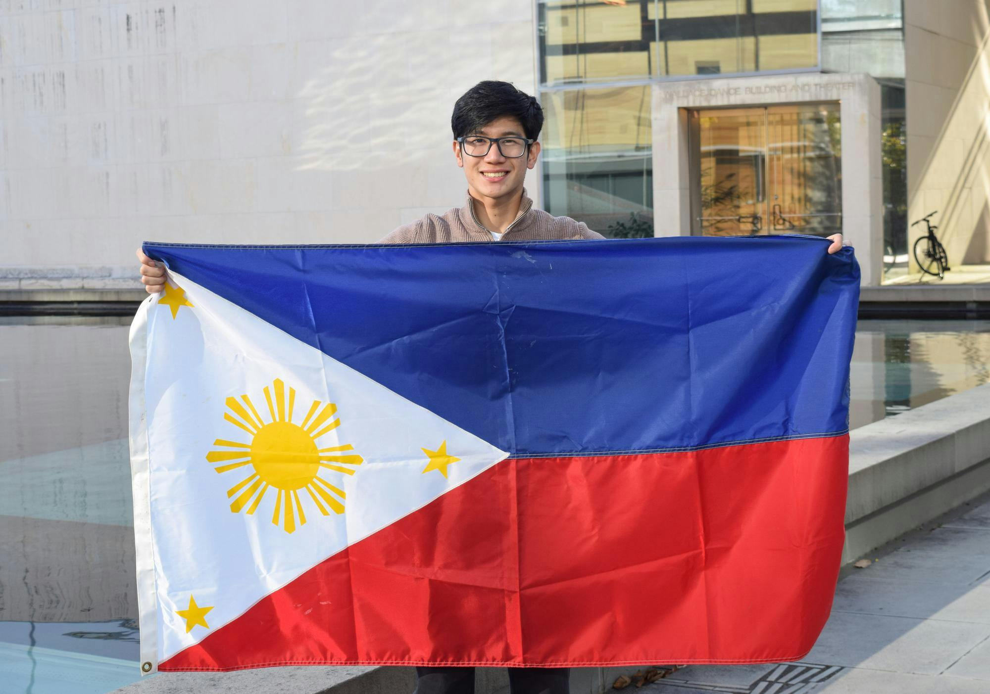 Student holds the flag of the Philippines. 