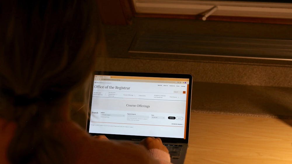Over the shoulder angle of a student browsing the Princeton course offerings webpage.