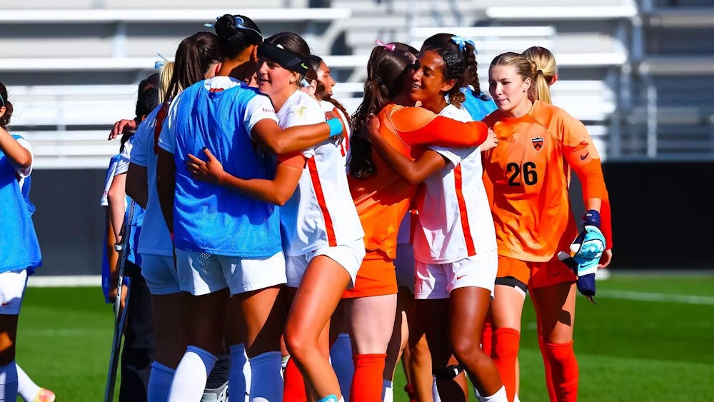 Team of Princeton soccer players hugging after practice session