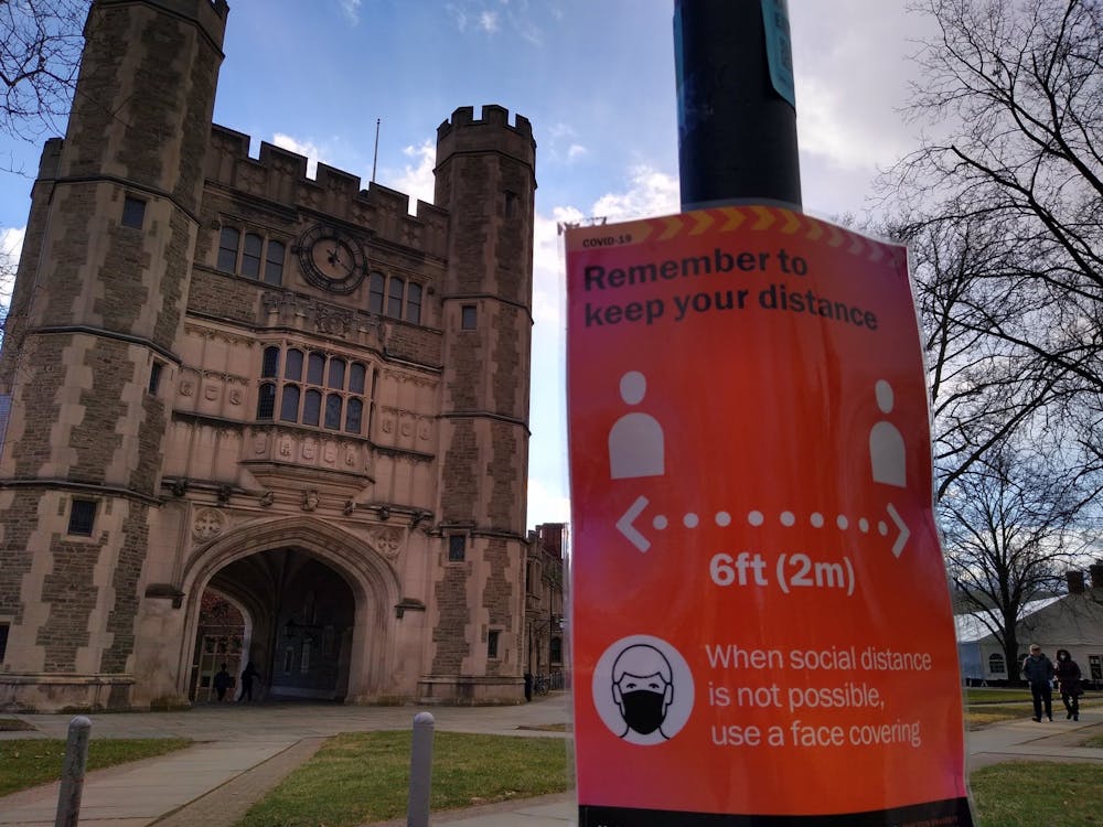 A sign promoting social distancing in front of Blair Arch.
Mark Dodici / The Daily Princetonian