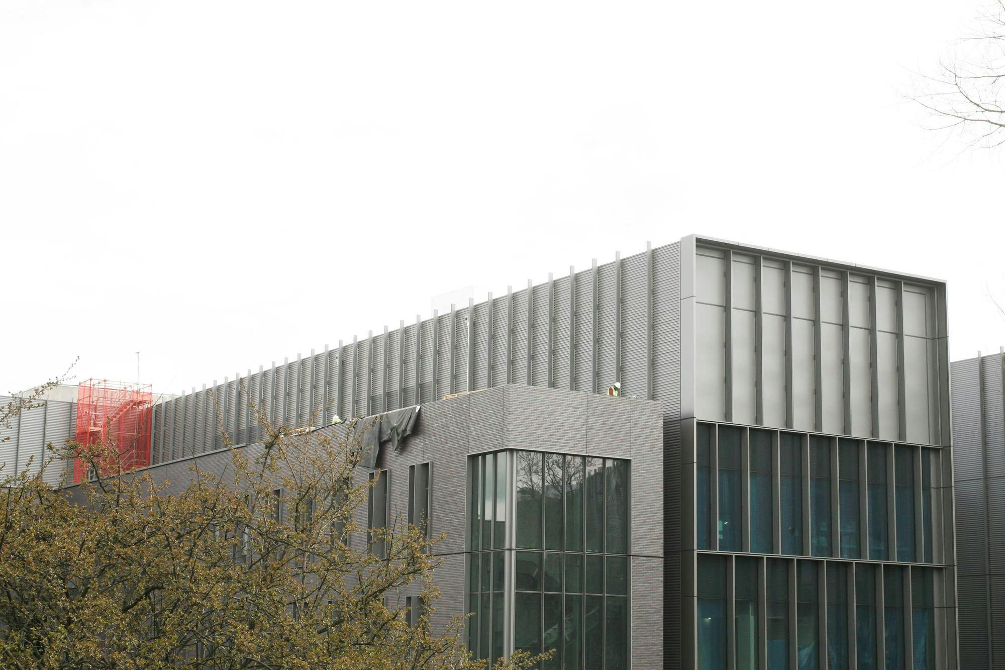 A grey building with blue windows.